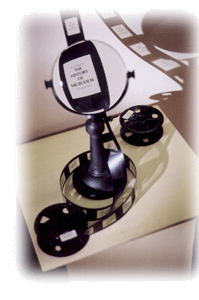 UC Southern Regional Library Facility Photo - Magnifying Glass over Microfilm